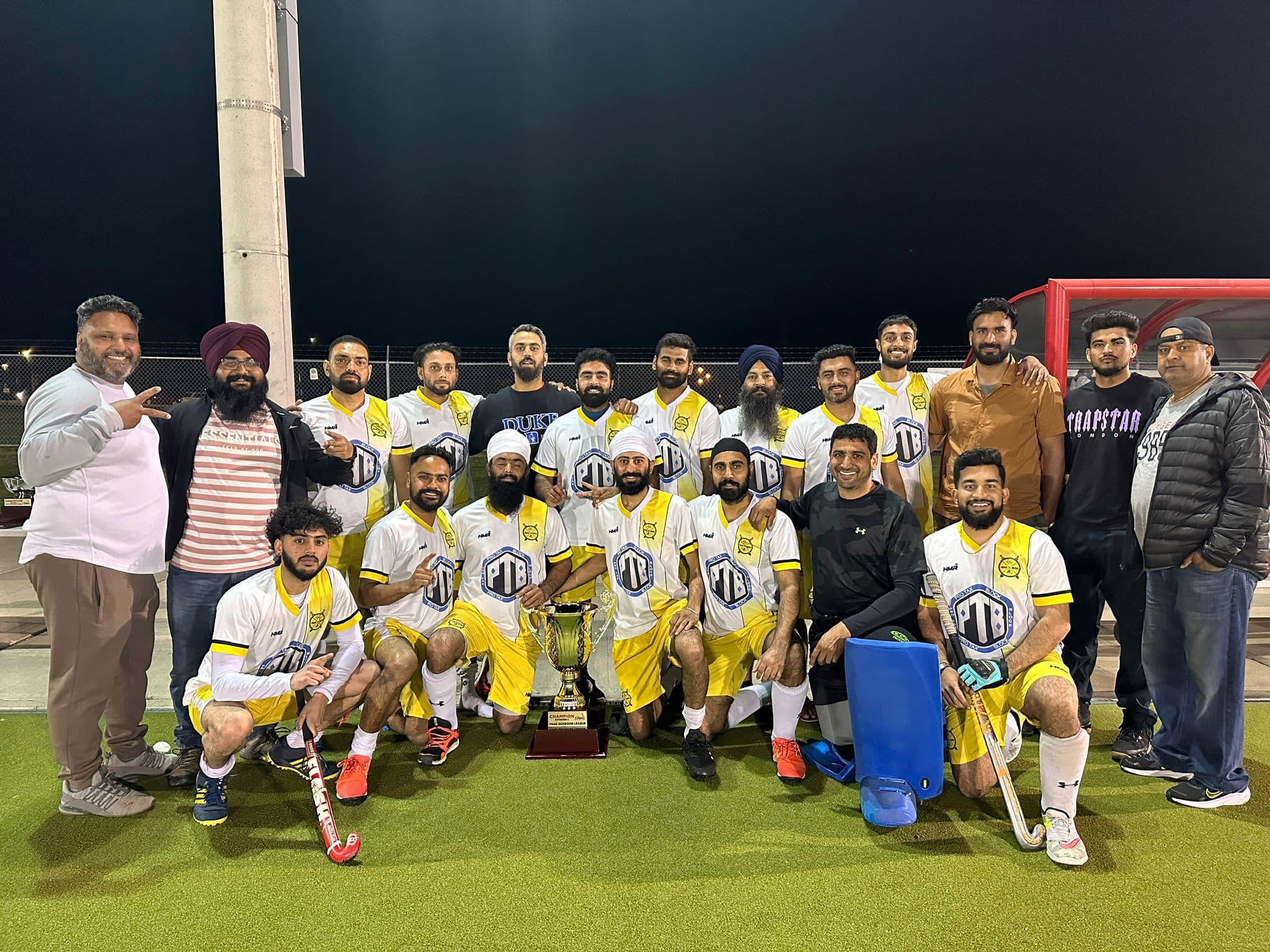 Team with trophy after night victory